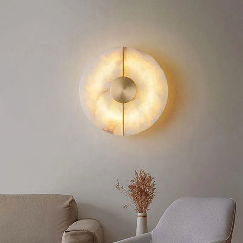 Applique marbre Maison Lumari, lumière chaude traversant la pierre naturelle